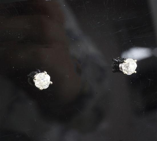 A pair of 18ct white gold and solitaire diamond ear studs,
